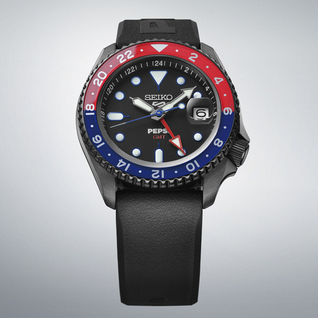 The Seiko 5 Sports SKX Series Pepsi Automatic 42.5mm Watch is a limited edition of 7,000 pieces, featuring a black dial, black strap, red and blue GMT bezel, luminous hands and markers, and a date window at 3 o'clock.