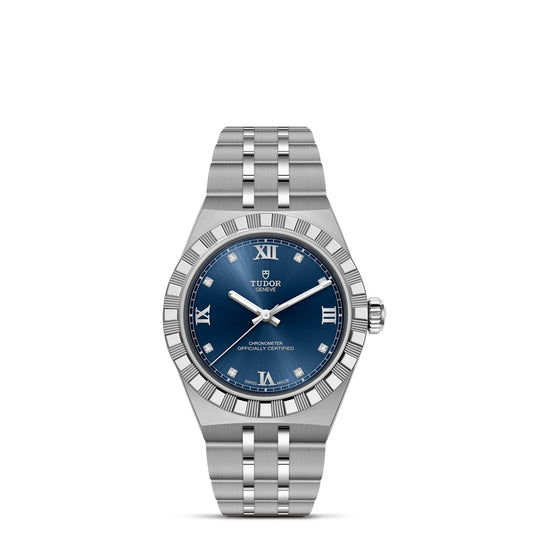 The TUDOR Royal by TUDOR features a silver case, blue dial with Roman numerals, and a metal link bracelet, highlighted on a white background—showcasing the refined sport-chic style of an automatic wristwatch.