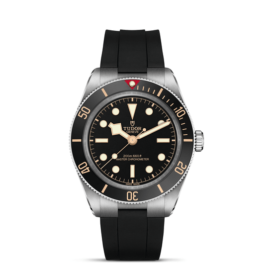 The TUDOR Black Bay 58 is a standout dive watch with a black dial, beige hour markers, luminous hands, rotating bezel featuring minute markings and a red triangle at 12 o’clock, plus a black rubber strap and stainless steel case.