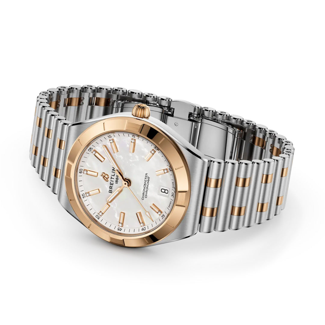 The BREITLING Chronomat Automatic 36 is a luxury watch featuring a two-tone silver and gold metal band, white mother-of-pearl dial, gold hour markers, date at 6 o’clock, and COSC-certified automatic movement—an elegant Breitling sports watch.