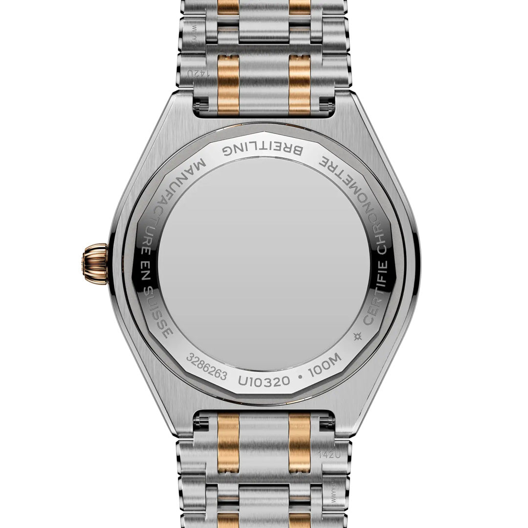 The image shows the back of a BREITLING Chronomat Automatic 36, a stainless steel sports watch with gold accents. The case back is engraved with "BREITLING," "MANUFACTURE EN SUISSE," and "100M.