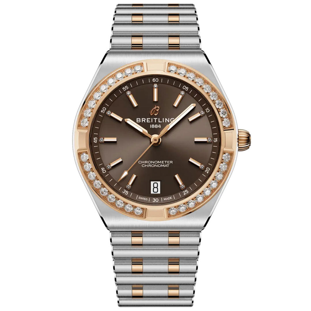 The BREITLING Chronomat Automatic 36 is a luxury sports watch with a two-tone silver-gold band, brown dial, gold accents, diamond-set bezel, date at 6 o’clock, and "Breitling 1884" at 12—COSC-certified for precision.