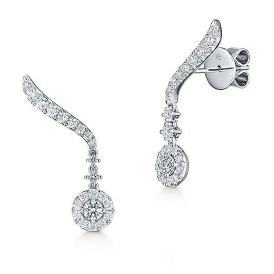 Introducing the Hearts On Fire Vela 18K White Gold Drop Earrings: These elegant earrings showcase a sophisticated curved design encrusted with small, sparkling diamonds. Each earring features a round diamond centerpiece gracefully hanging beneath the curve, epitomizing luxury and sophistication as part of our Fine Jewelry Collection by Hearts on Fire.