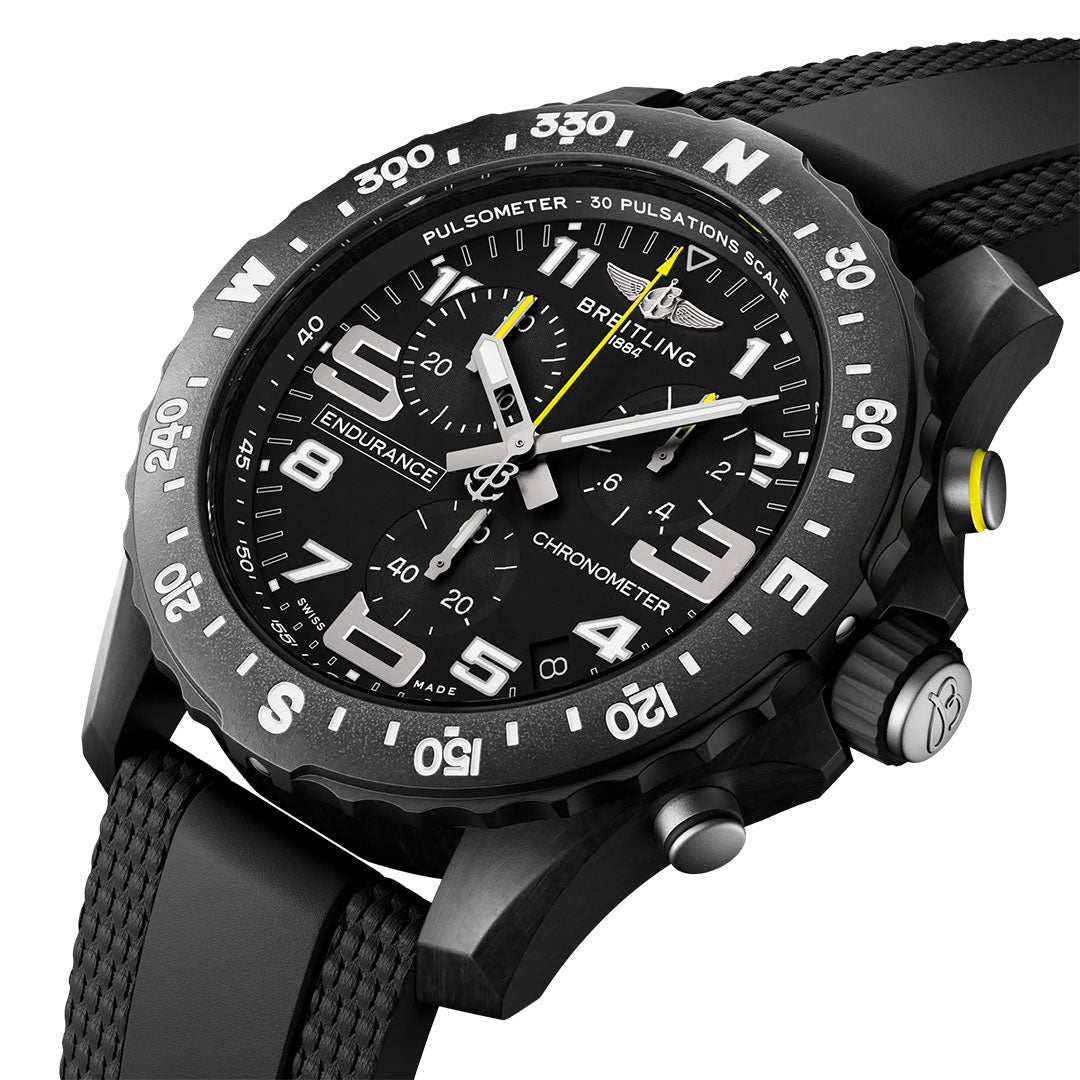 A close-up of the BREITLING Endurance Pro 44 chronograph by Breitling, featuring a durable black case, textured black strap, yellow accents, bold white numerals and hands, plus a bezel with numbers and pulsometer scale.