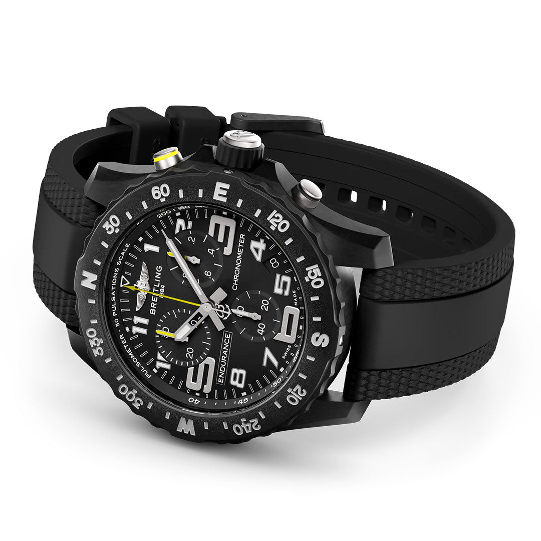 The BREITLING Endurance Pro 44 sports chronograph wristwatch by Breitling features a black rubber strap, large white numerals, multiple chronograph dials, a rotating bezel, yellow-tipped second hand, and a durable Breitlight case.
