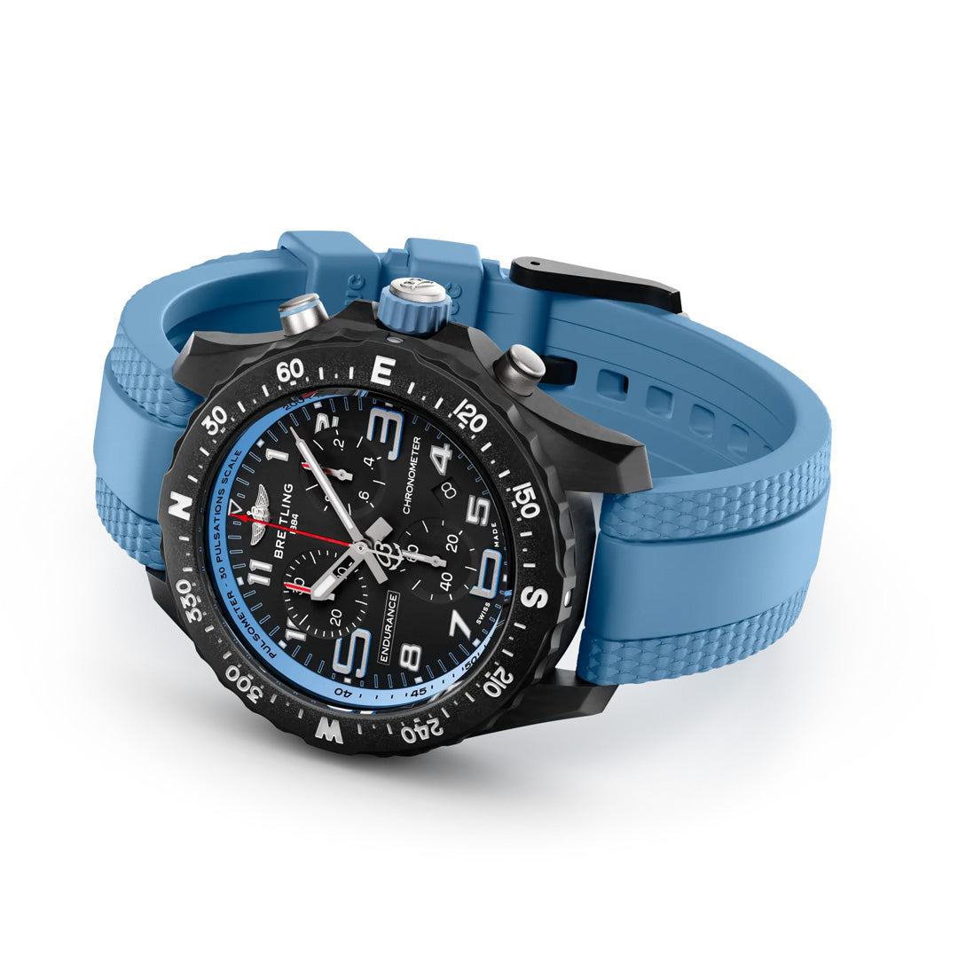 The BREITLING Endurance Pro 38 by Breitling is a sleek athleisure chronograph with a black face, blue numerals, multiple dials, a textured blue strap, ultra-light Breitlight® case, rotating bezel, and bold hour markers.