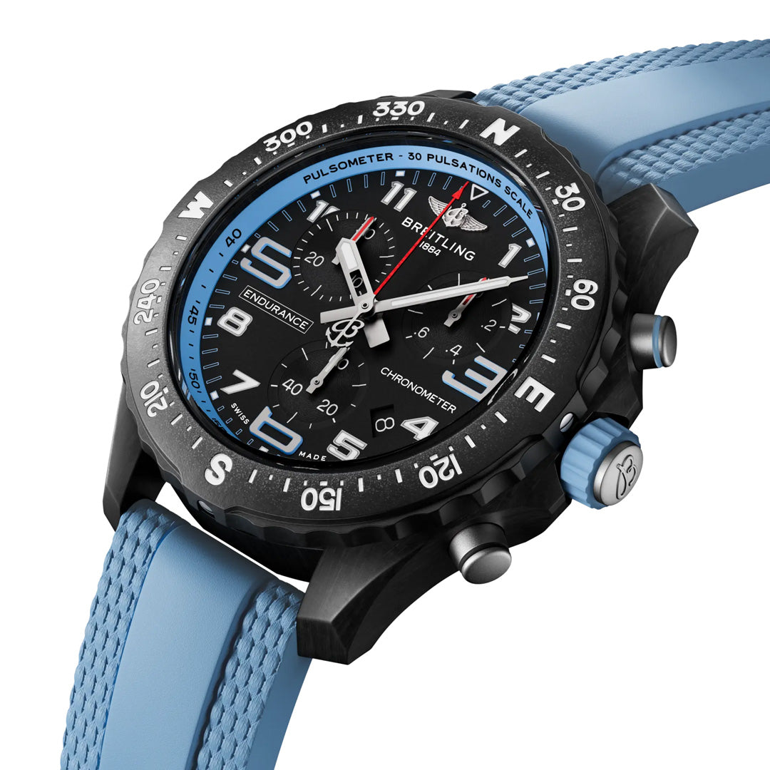 The BREITLING Endurance Pro 38 by Breitling features a sleek black face with blue accents, an ultra-light Breitlight® case, three subdials, a tachymetric scale, and a textured blue rubber strap. Bold white numerals highlight its detailed sports chronograph functionality.