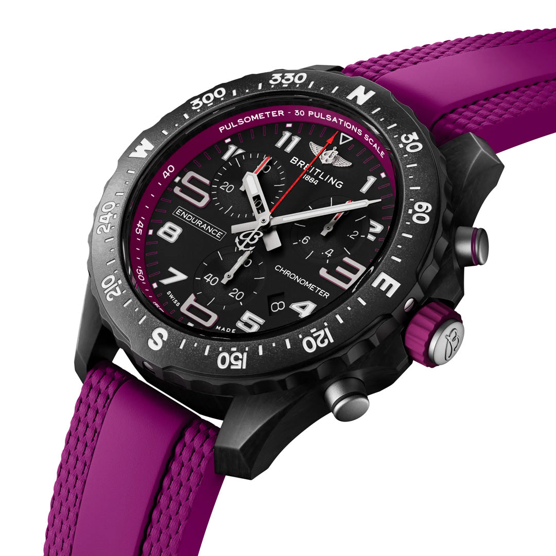 The BREITLING Endurance Pro 38 athleisure watch in black and magenta features a durable Breitlight® case, tachymeter scale, magenta rubber strap, and luminescent hands on a white dial.