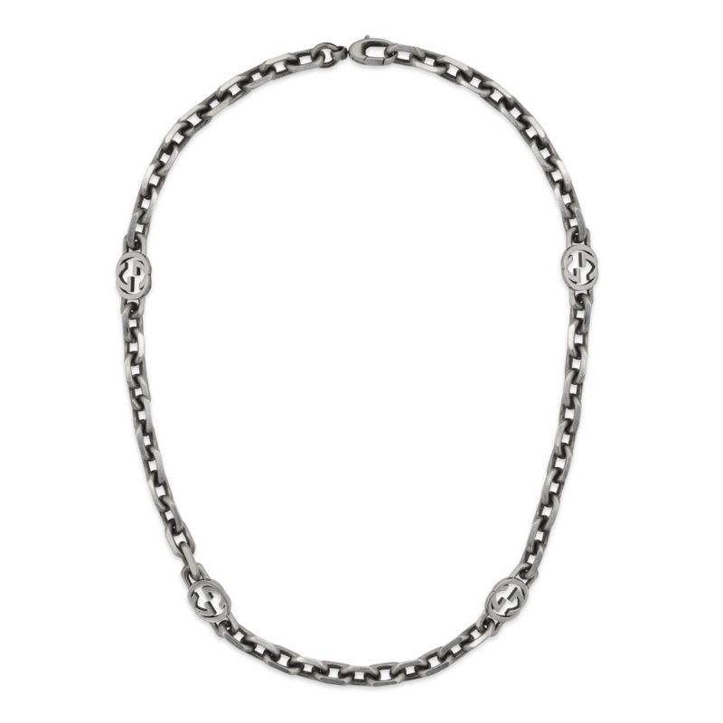 The Gucci Interlocking G Sterling Silver Station Necklace from GUCCI Fine Jewellery showcases a polished linked design adorned with four round decorative elements and secured by a clasp closure. Drawing inspiration from the iconic Interlocking G motif, it exemplifies Gucci's renowned elegance and craftsmanship.