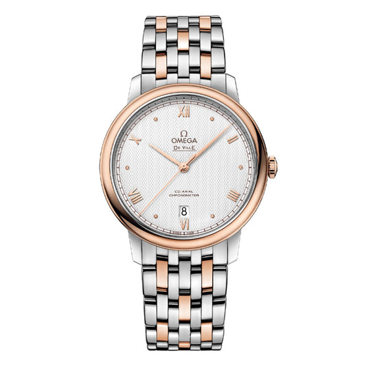 The OMEGA De Ville Prestige Co-Axial Chronometer 39.5mm Watch is a luxury wristwatch with a white textured dial adorned with gold Roman numerals and a date display at the 6 o'clock position. This model features the Co-Axial calibre 2500 movement, complemented by a stainless steel and rose gold two-tone bracelet along with a matching rose gold bezel, proudly displaying "Omega De Ville.