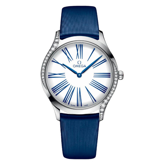 Discover the OMEGA De Ville Trésor Quartz 36mm Watch, a women's timepiece in stainless steel with a silver finish. It features a white dial adorned with striking blue Roman numerals and is complemented by an elegant blue leather strap. The bezel is embellished with diamond-like sparkling details, creating an elegantly classic design.