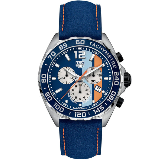 The TAG Heuer Formula 1 Chronograph Special Edition Quartz 43mm Watch showcases a sky-blue dial with three subdials, a tachymeter bezel, bold orange stripe accents, white indices, and a blue strap highlighted by orange stitching.