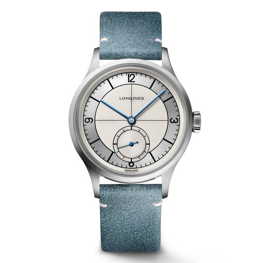 Embrace the vintage charm of the Longines Heritage Classic Automatic 38.5mm Watch. This timepiece showcases a silver case paired with a light blue leather strap. Its cream dial is adorned with blue hands, Arabic numerals positioned at 3, 9, and 12 o'clock, and features a subdial at 6 o'clock beneath the scratch-resistant sapphire crystal.