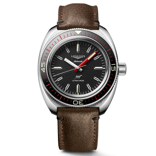 The Longines Ultra-Chron Box Edition Automatic 43mm watch, a classic wristwatch by Longines, exudes luxury with its dark dial featuring red and white details and a silver bezel. Its brown leather strap complements the silver hour markers while housing a high-frequency calibre, with the brand name proudly displayed on the dial.