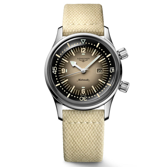 The Longines Legend Diver Automatic 36mm watch by Longines is a horological masterpiece, boasting a stainless steel case, a beige dial complemented by silver hands, and bold hour markers. It features a date window at 3 o'clock and includes two crowns on the right side. The cream fabric strap complements the black bezel with white markings, making it a standout in the Heritage segment.