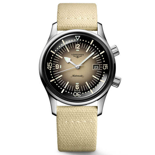 The Longines Legend Diver Automatic 42mm Watch captures the essence of the 1960s with its silver case, beige gradient dial, and white hour markers. Its beige fabric strap harmonizes with the dual crowns and a date window at 3 o'clock, while "Automatic" is elegantly displayed in the center. This iconic timepiece from Longines is built to endure through history.