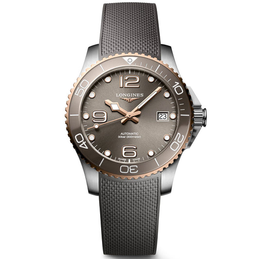 This elegant Longines HydroConquest Automatic 39mm Watch showcases a gray textured strap and matching dial. It includes a bronze bezel adorned with bold Arabic numerals. The date window is positioned at 3 o'clock, accompanied by arrow-shaped hour hands and sword-shaped minute hands illuminated with Swiss Super-LumiNova.