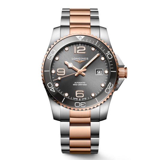 As part of the Longines Sport Collection, the Longines HydroConquest Automatic 41mm Watch boasts a copper and silver two-tone metal band complemented by a sleek silver and black bezel. The gray dial is adorned with silver Arabic numerals and markers, along with a date window at the 3 o'clock position. Copper-toned hands imbue this timepiece with elegance and precision.