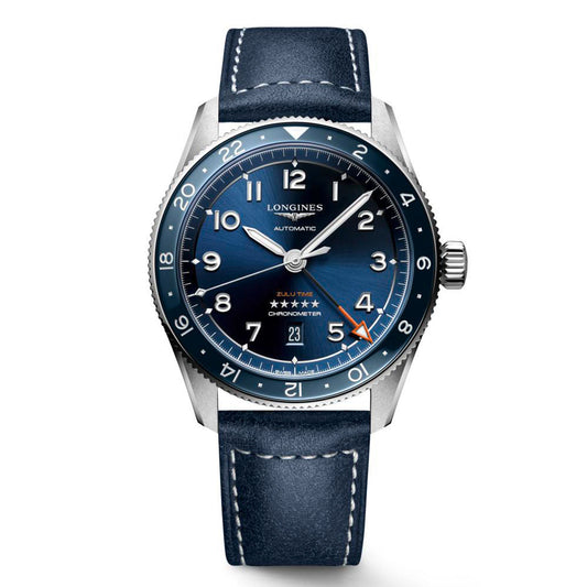 The Longines Spirit Zulu Time Automatic 42mm Watch showcases a blue leather strap and a round blue dial with white numerals and silver hands. Drawing inspiration from the golden era of aviation, it includes an orange arrow-tipped second hand, a date display at 3 o'clock, and a numbered bezel, all driven by a self-winding mechanical movement.