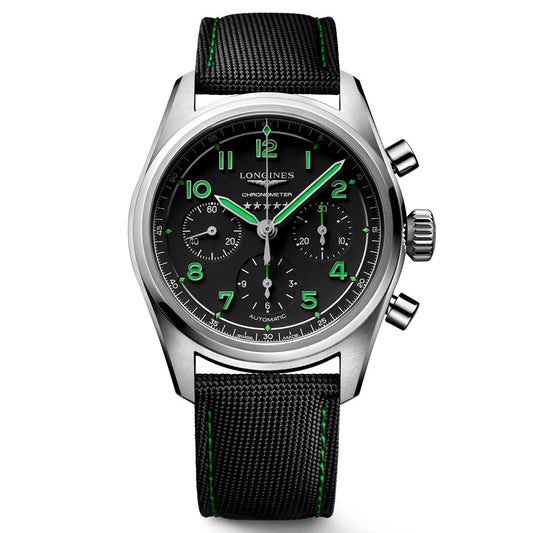 The Longines Spirit Pioneer Edition Automatic Chronograph 42mm Watch showcases a white-on-black dial adorned with green and white numerals, along with three subdials. It is complemented by a black strap featuring green stitching. Its COSC-certified automatic movement ensures precision, while the Longines brand name is elegantly displayed on the dial.