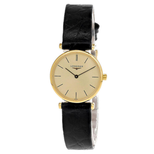 The Longines La Grande Classique Quartz 24mm Watch embodies timeless sophistication with its round, gold-tone case and beige dial featuring slender black hour markers. Its slim profile is perfectly paired with a black leather strap that fastens with an understated buckle. The dial elegantly displays the Longines brand name.