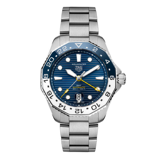 The TAG Heuer Aquaracer Professional 300 GMT Automatic 43mm Watch is a luxury sports timepiece featuring a bold blue patterned dial, silver hour markers, and a distinctive blue and white 24-hour bezel. Powered by TAG Heuer’s precise Calibre 7 GMT movement, it includes a vibrant yellow GMT hand and a convenient date window at 6 o’clock. This watch is completed with a durable stainless steel bracelet for both style and performance.